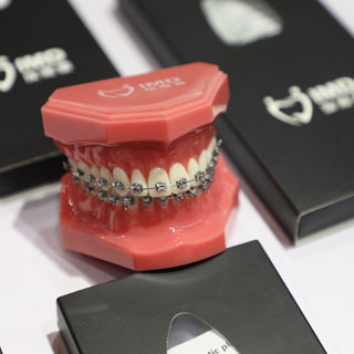 Metal orthodontic bracket - ActMIM - Innovative Material and Devices, Inc. - self-ligating / rectangular / round