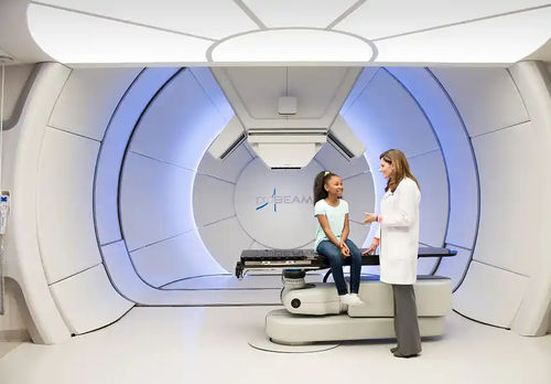 Proton therapy cyclotron with robotized positioning table - ProBeam - Varian Oncology - with integrated CT scanner