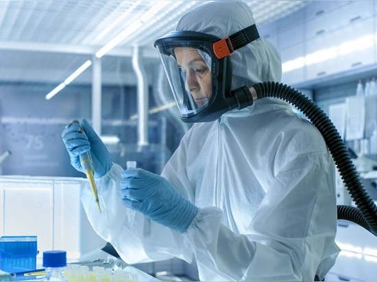 Laboratory worker, wearing a Powered Air-Purifying Respirator (PAPR).